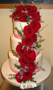 Buttercream and Cascading Red Rosed and Blossoms